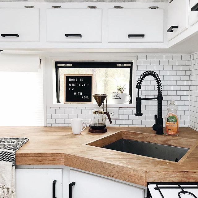 Modern kitchen in The Mayes Team skoolie bus showing what is covered in school bus conversion cost.