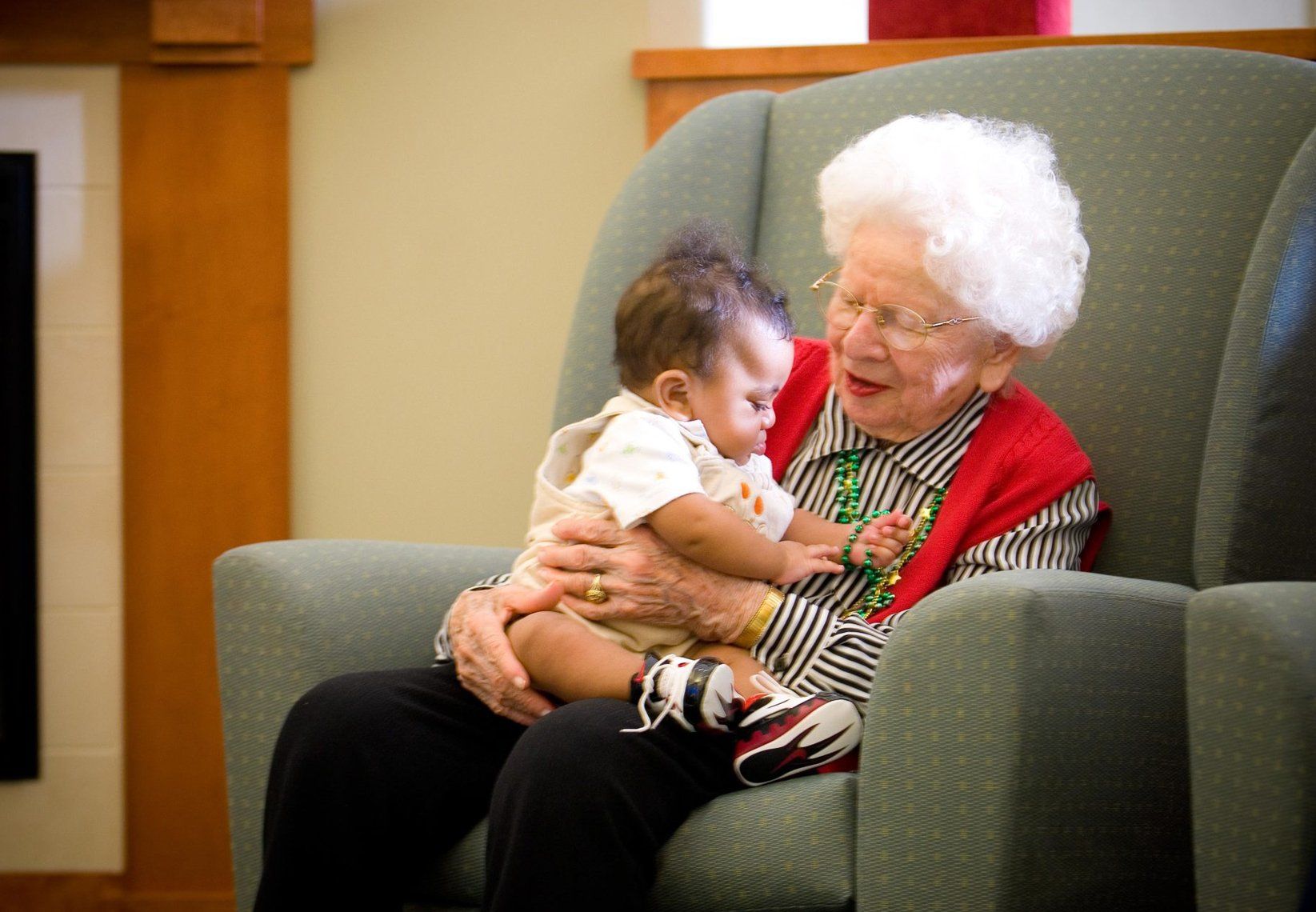 Elder Care — Happy Elderly Woman Holding A Baby In Spring, MD Elder Care — Happy Elderly Woman Holding A Baby In Spring, MD