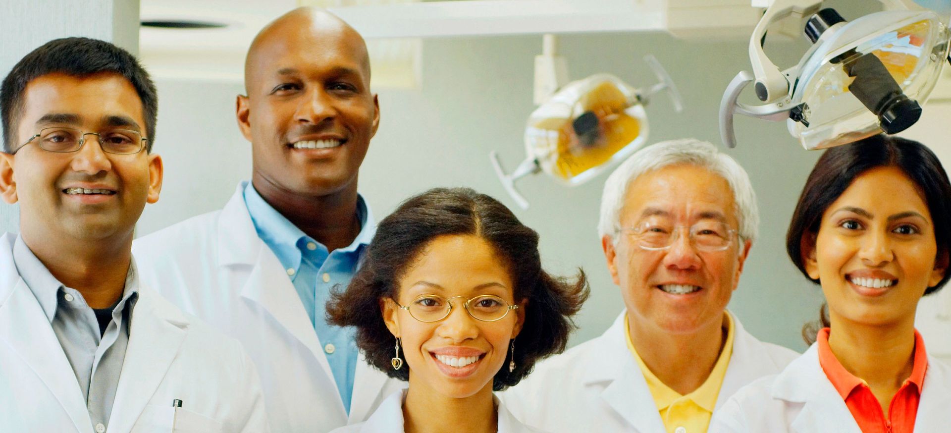 A group of dentists posing for a picture in a dental office