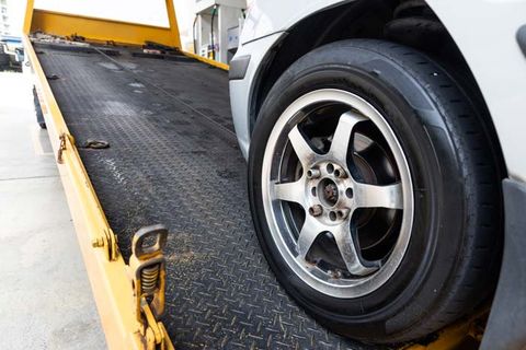 Car Being Loaded to Tow Truck — Columbiana, AL — Howard Tire Service, Towing and Recovery Car Being Loaded to Tow Truck — Columbiana, AL — Howard Tire Service, Towing and Recovery