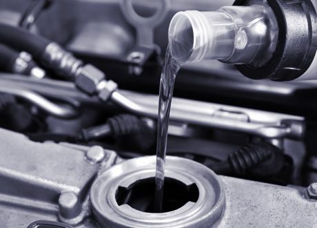 Man refilling the oil in his car
