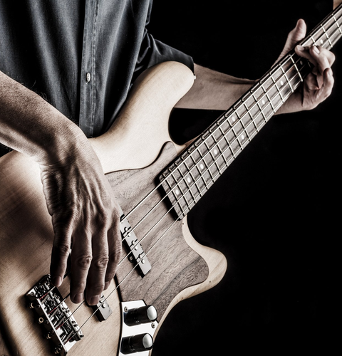 Male teacher teaching girl to play guitar