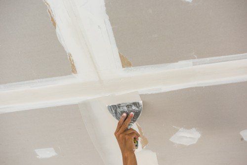 un uomo che mette dello stucco con una cazzuola sul muro