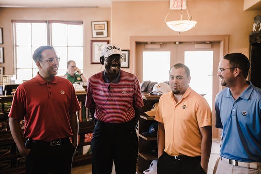 A group of men are standing next to each other in a room.