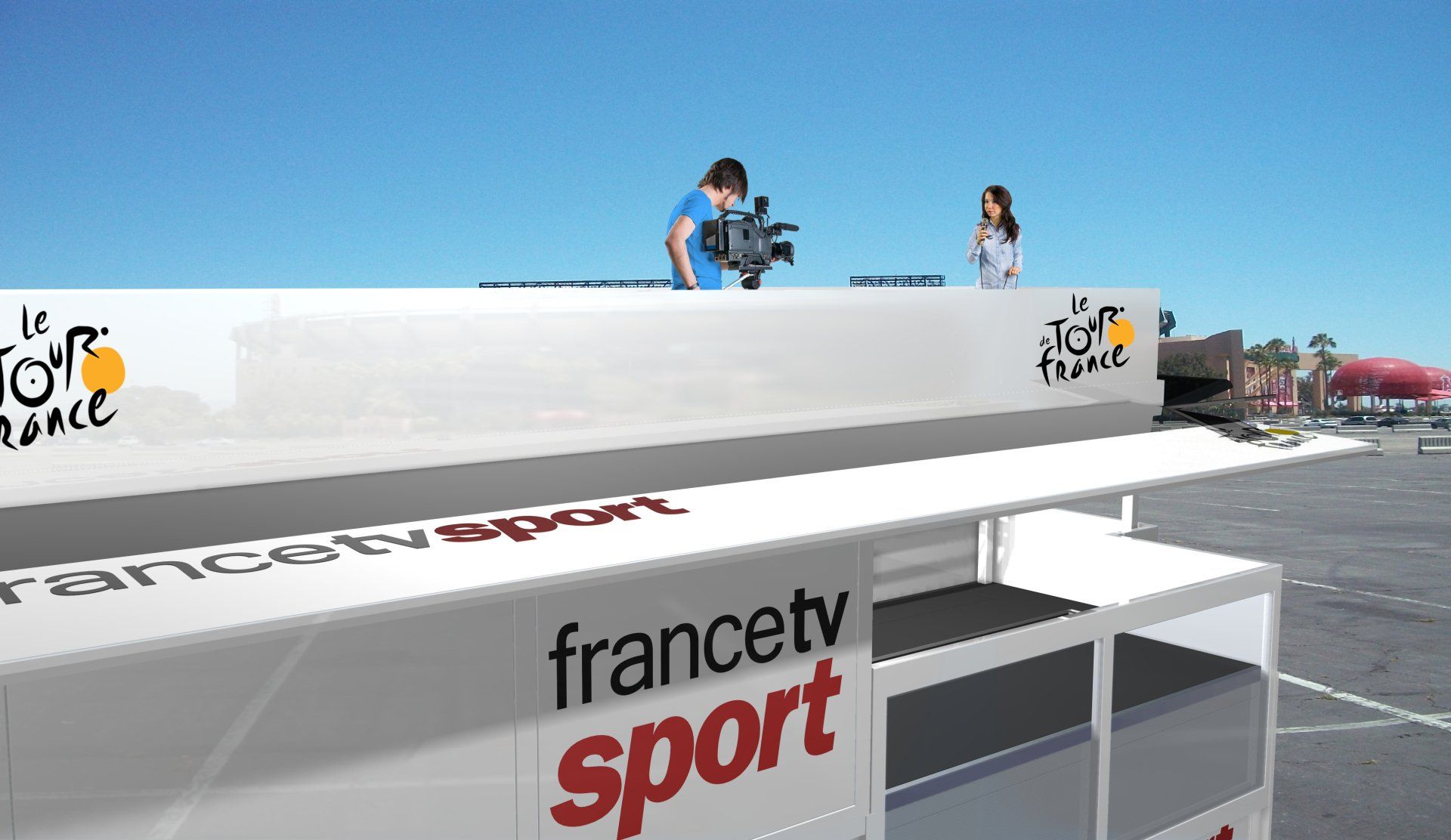 Cyclists racing past a France TV Sport podium under a bright blue sky