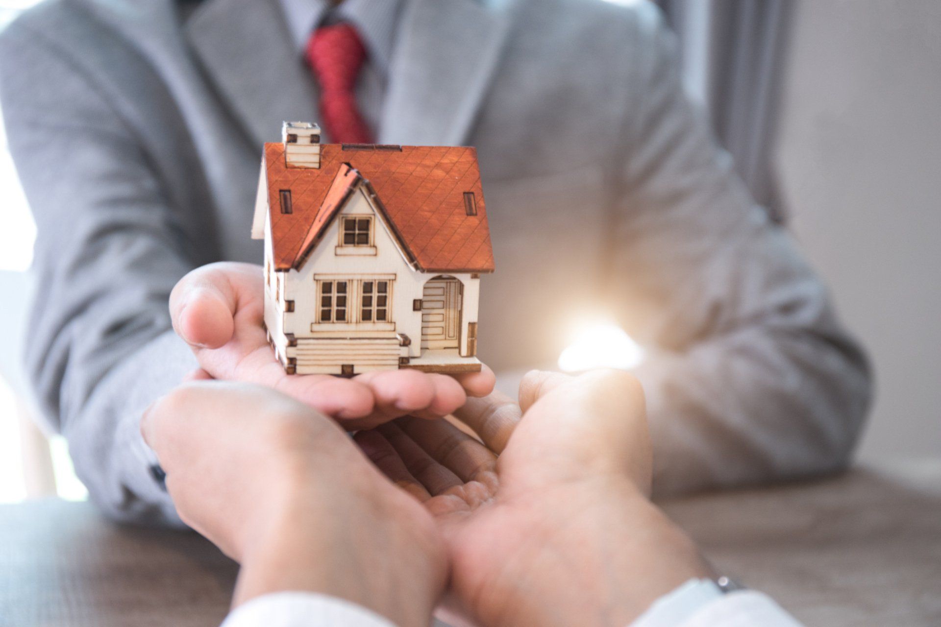 hands holding a house