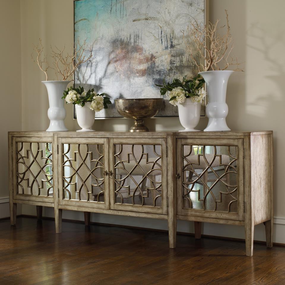 Cabinet with home décor on top and a painting in the background