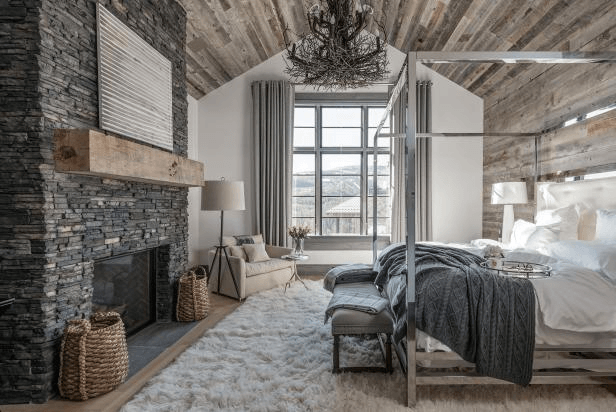 bedroom with wood ceiling and stone fireplace