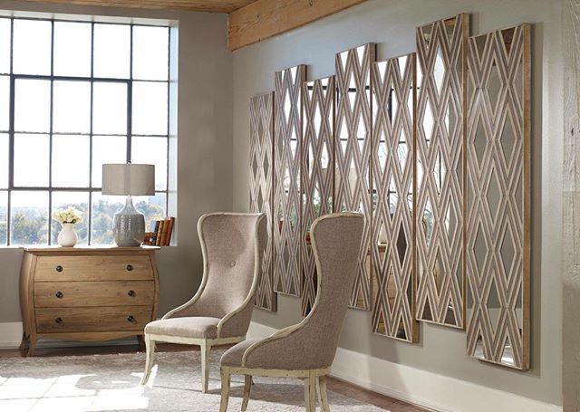 Two chairs with decorative wall art behind them in Laredo, TX
