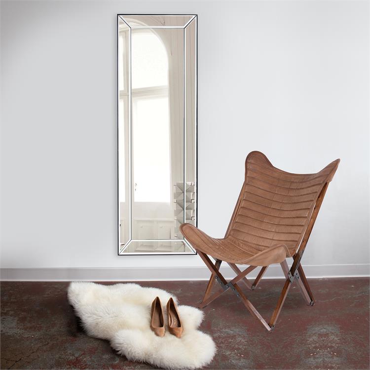 Home décor on wall with chair and area rug in foreground