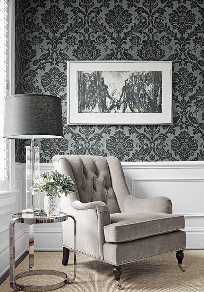 Living room furniture in wallpapered room with home décor and home lighting