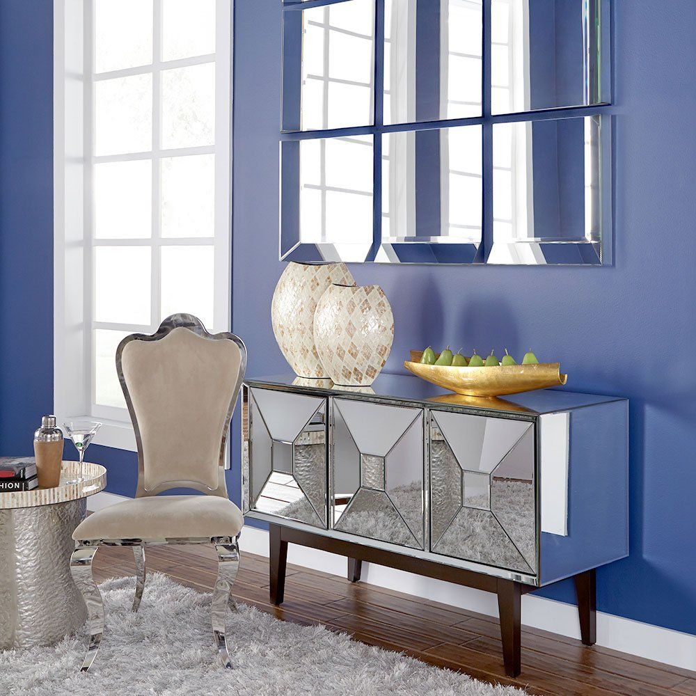 Home décor such as vases and pears on top of a table with a mirror in the background