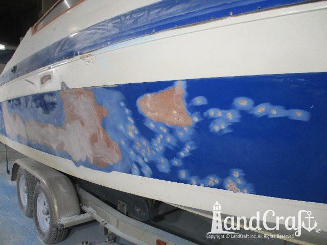 Wellcraft boat in process of exterior fiberglass and gelcoat repair