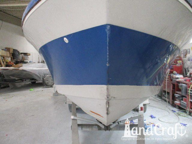 Wellcraft boat in process of exterior fiberglass and gelcoat repair