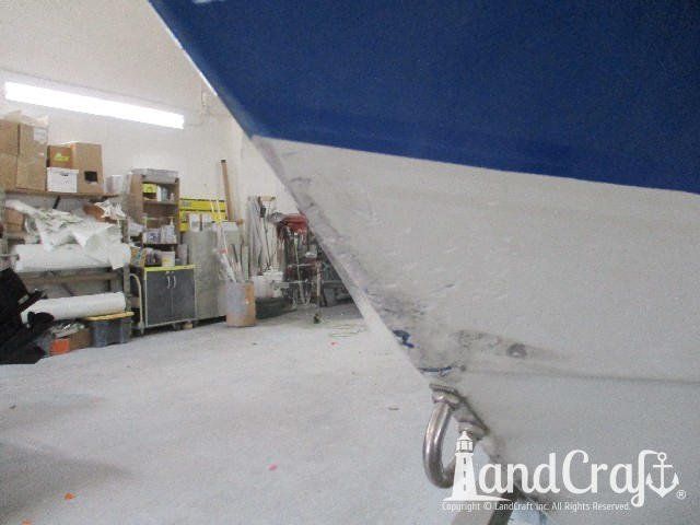 Wellcraft boat in process of exterior fiberglass and gelcoat repair