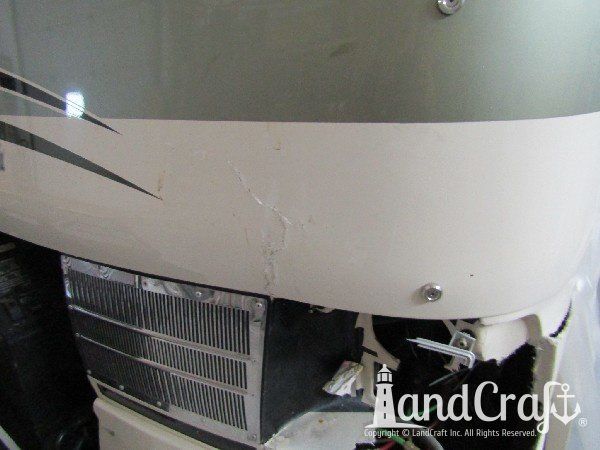 Country Coach motor coach with front end damage in the repair process