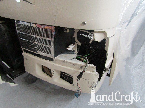 Country Coach motor coach with front end damage in the repair process