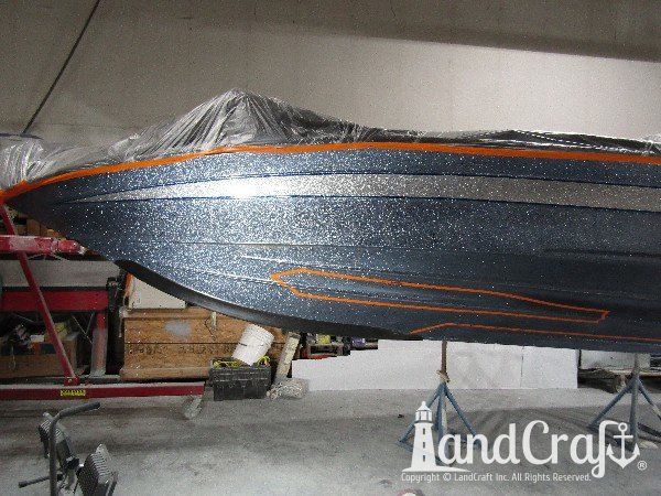 Legend boat with multiple areas of metalflake damage in multiple colors
