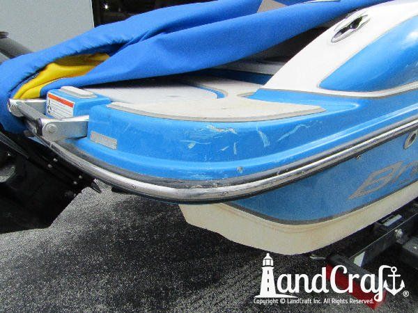 Accident damage along the swim deck of a fiberglass Bryant boat