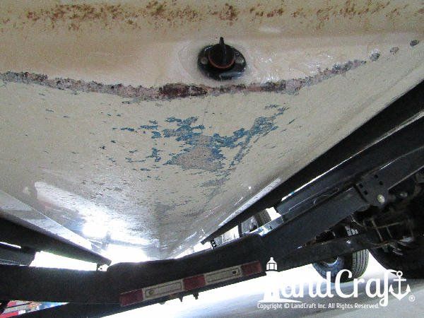 Grounding damage on the bottom of a fiberglass Bryant boat