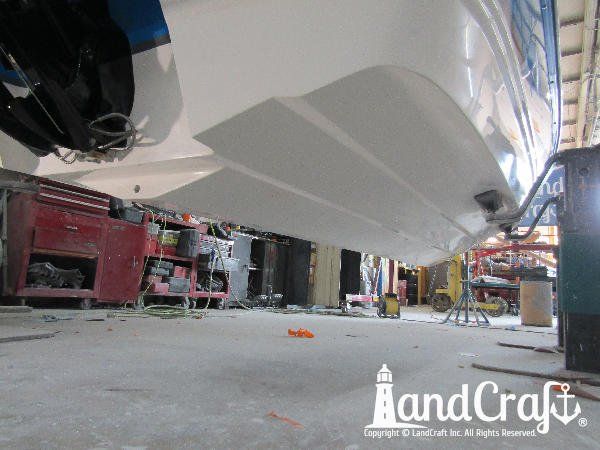 Gelcoat refinishing process near completion on bottom of a Bryant boat