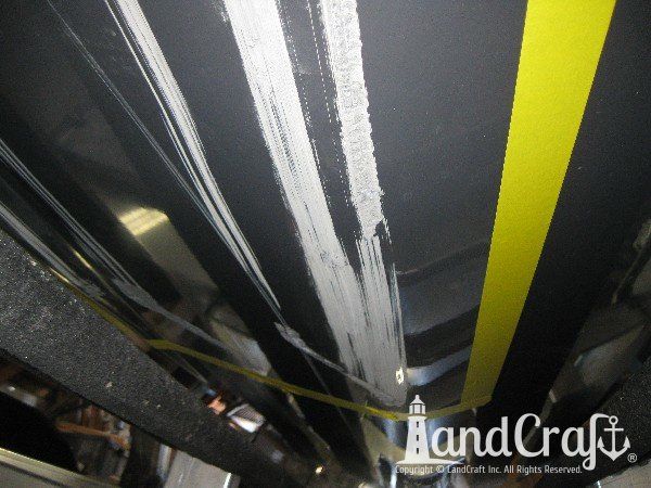 Grounding damage on hull of Nauticstar center console fiberglass boat