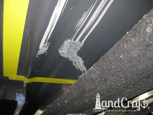 Grounding damage on hull of Nauticstar center console fiberglass boat