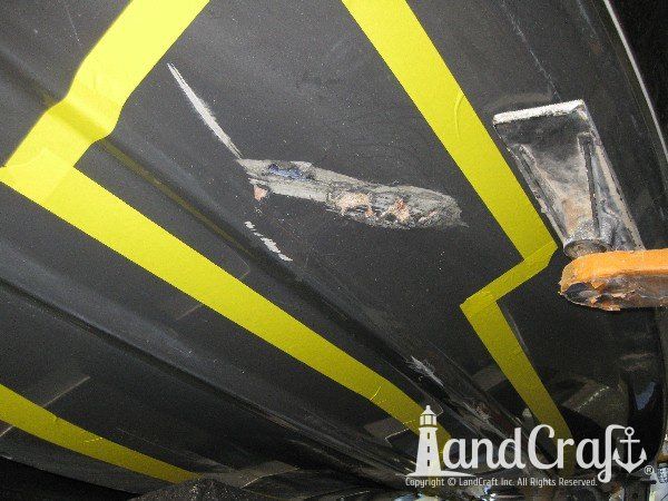 Grounding damage on hull of Nauticstar center console fiberglass boat