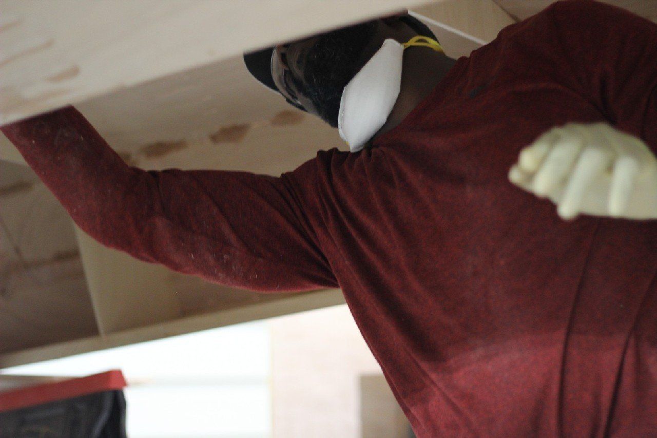 Charles is applying materials to the Row4Kids boat
