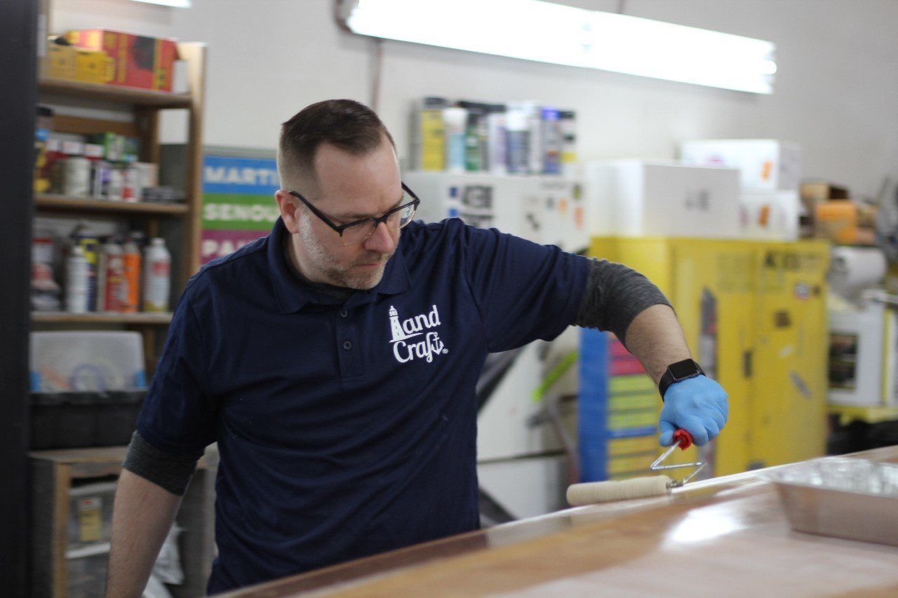 Jake is applying materials to the Row4Kids boat
