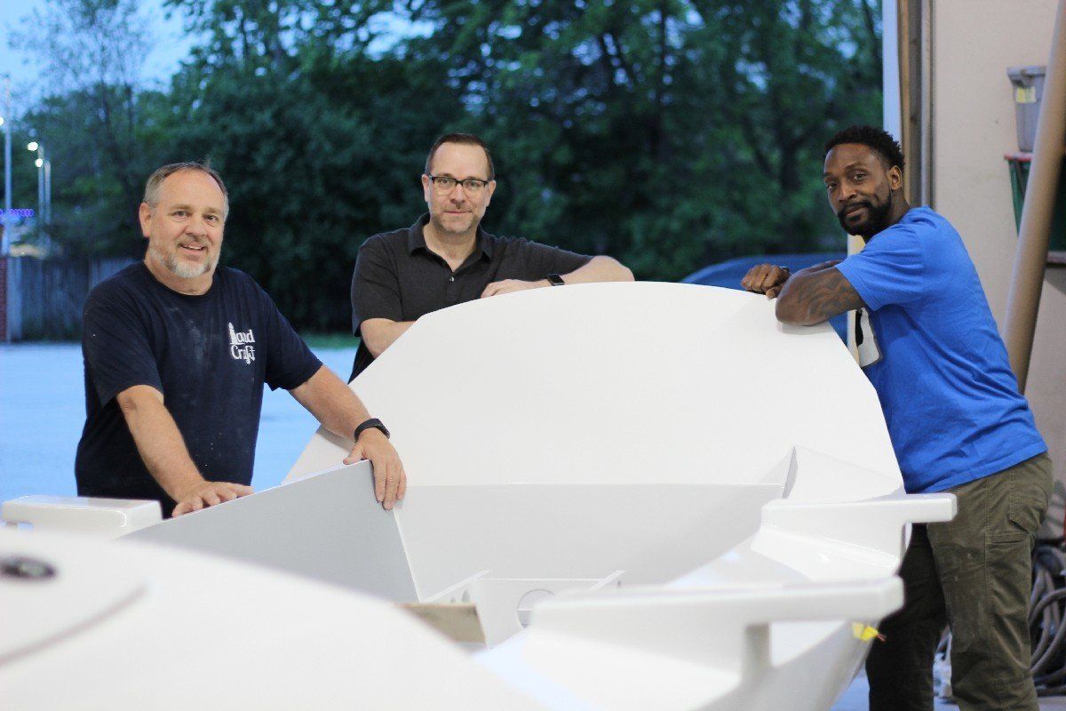 Keith Lekberg with Charles Tillman and the Row4Kids boat at LandCraft