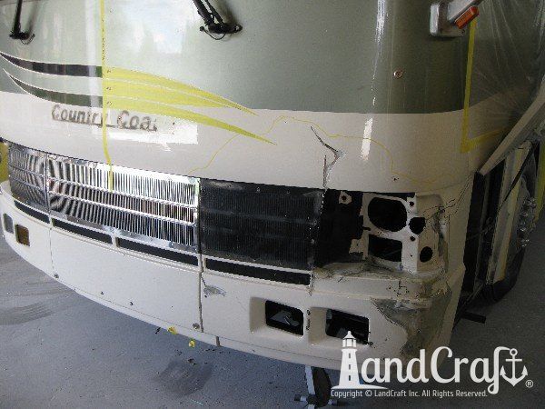 Country Coach motor coach with front end damage in the repair process