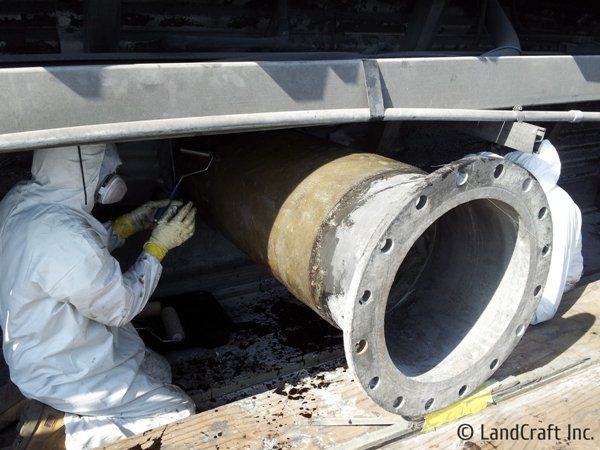 Picture of worker fixing an industrial fiberglass pipe