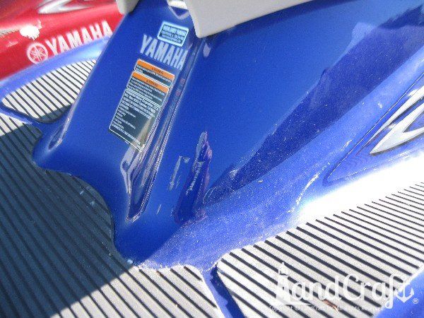 Blue Yamaha with scratches across the back seat base