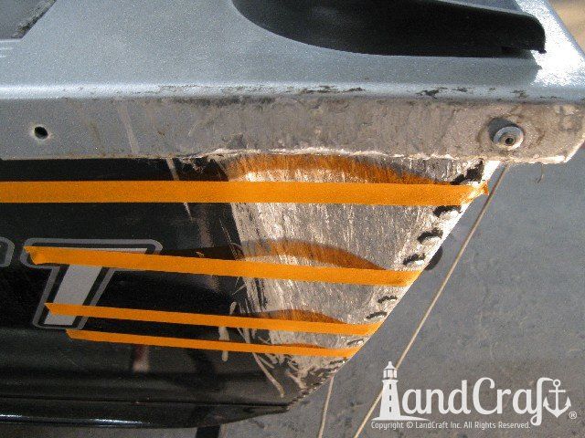 Picture of scratches and large dent on an aluminum boat