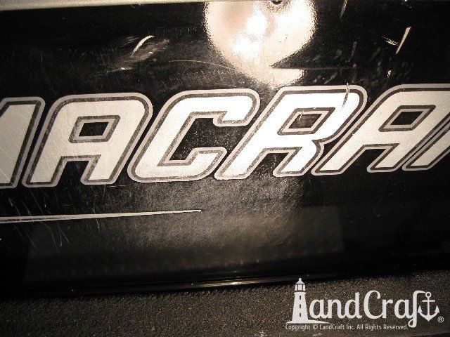 Picture of scratches through paint and decals on an aluminum boat
