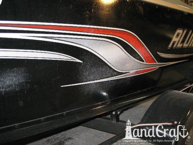Picture of scratches through paint and decals on an aluminum boat