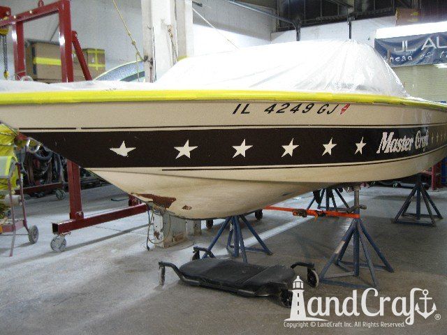 Mastercraft Stars & Stripes boat on a lift and ready for exterior repairs and gelcoat refurbishing