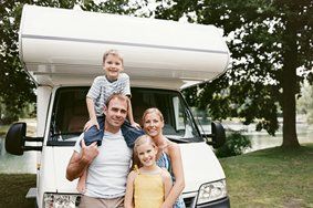 Family Standing Next to RV — Vehicles Insurance in Cambridge, MD Family Standing Next to RV — Vehicles Insurance in Cambridge, MD