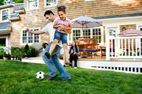 Father Playing Soccer with Daughter — Home Owners Insurance in Cambridge, MD Father Playing Soccer with Daughter — Home Owners Insurance in Cambridge, MD