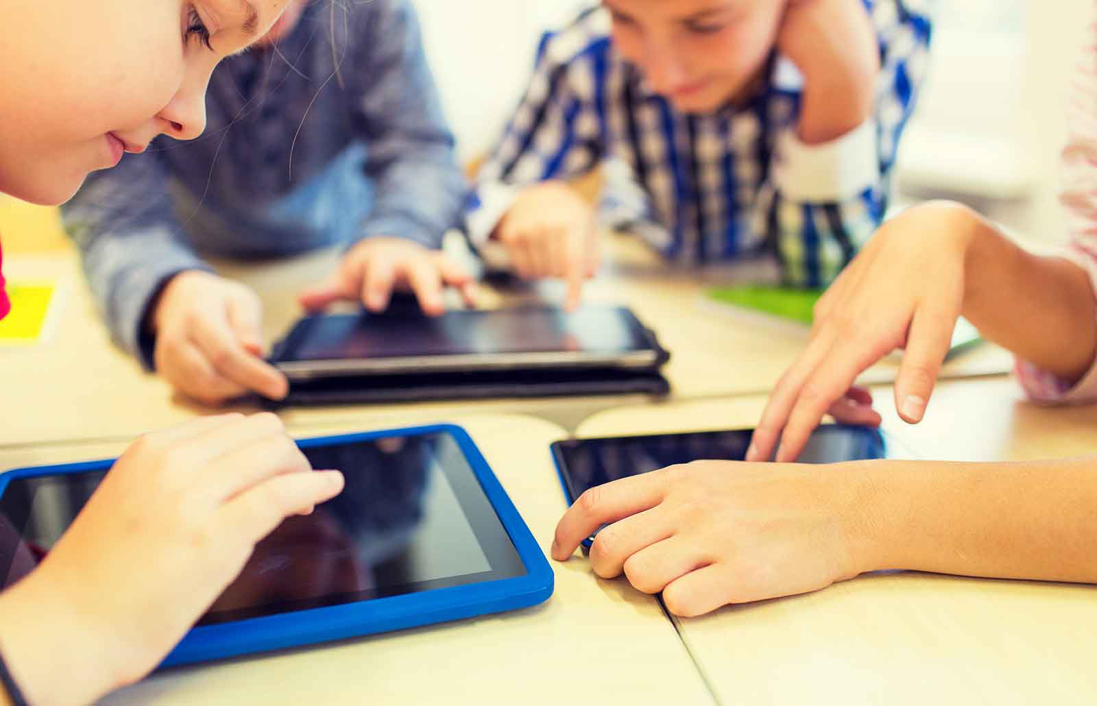 The Importance of Penmanship in Children: Children looking and interacting with touch screen devices
