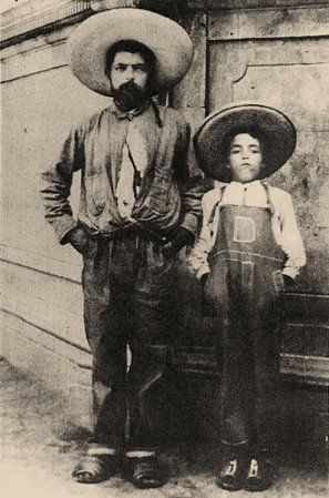 A black and white photo of a man and a boy standing next to each other