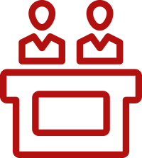 A red icon of two people sitting at a table.