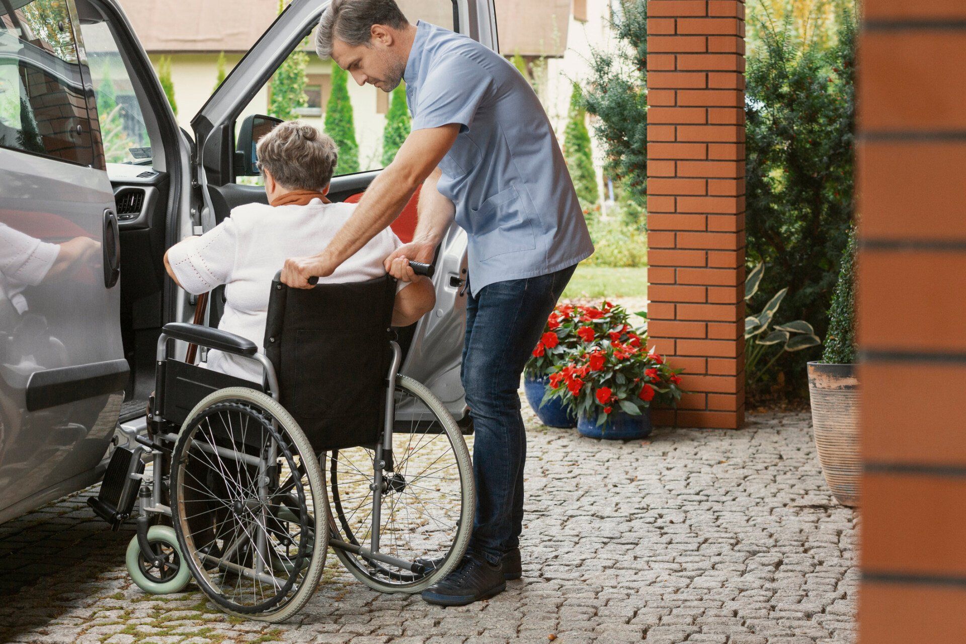 Nurse Helping Senior Woman On The Wheel Chair — South Sioux City, NE — Live Well Home Care Nurse Helping Senior Woman On The Wheel Chair — South Sioux City, NE — Live Well Home Care