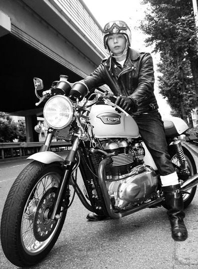 A man is sitting on a motorcycle wearing a helmet and goggles.