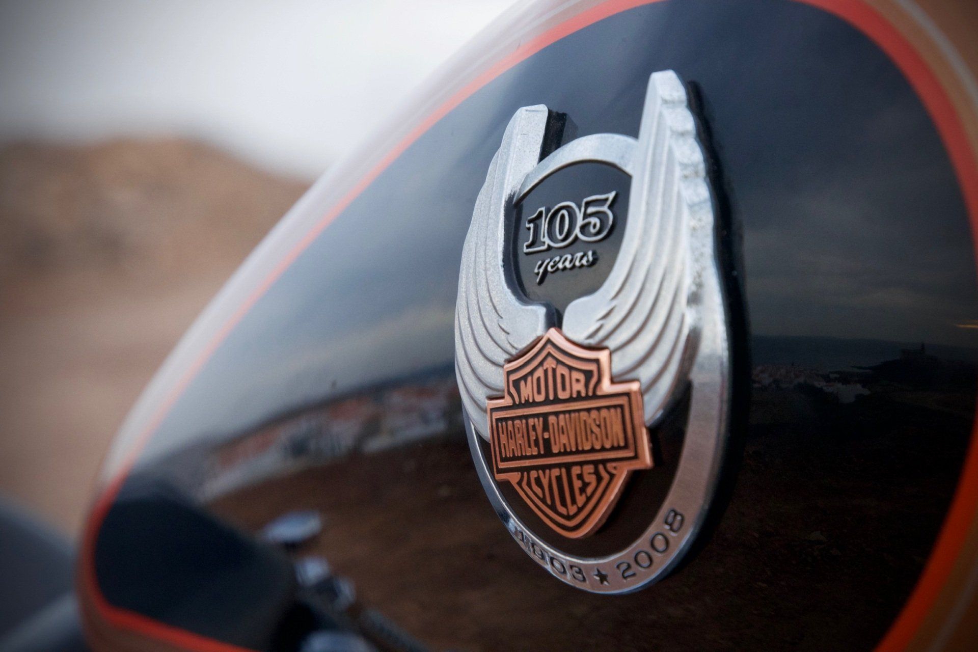 A close up of a harley davidson emblem on a motorcycle