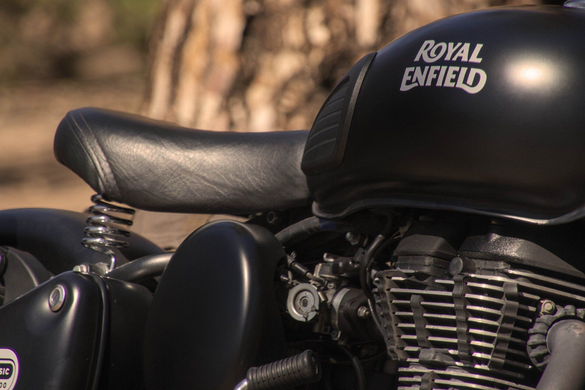 A close up of a black royal enfield motorcycle