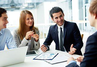 Image of business partners discussing documents and ideas at meeting