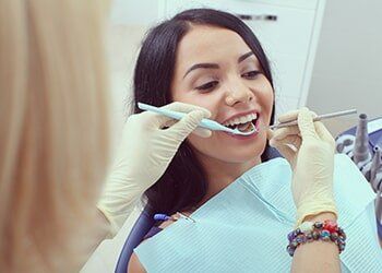 Female Dentist Cleaning Female Patient Teeth—Dentists in Whittier, NC Female Dentist Cleaning Female Patient Teeth—Dentists in Whittier, NC