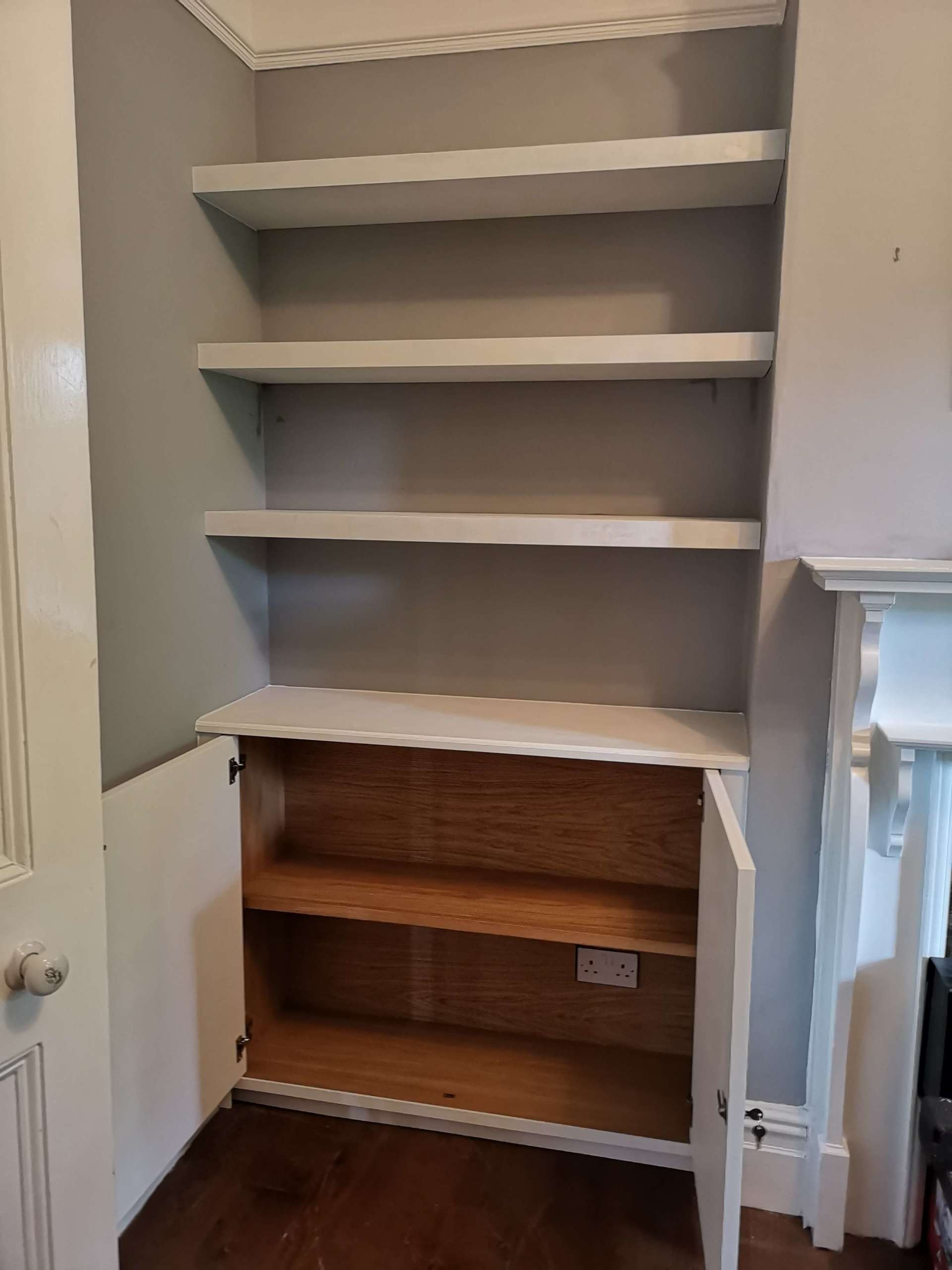 Alcove unit with oak veneer internals, floating shelves and shaker beaded doors. Painted white